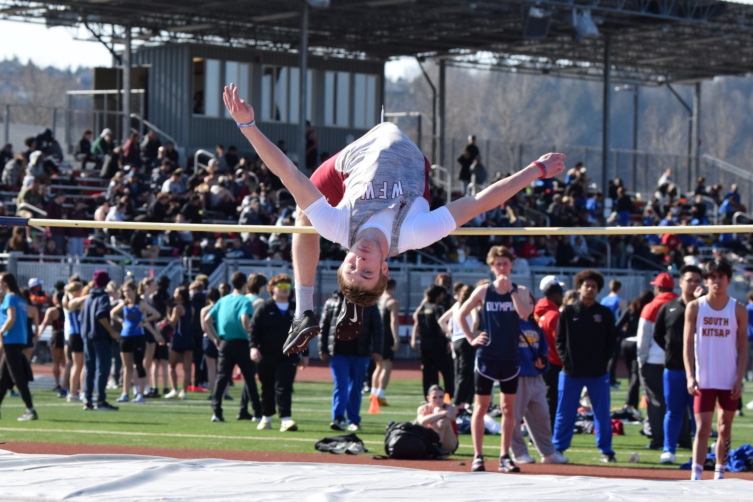 Lucas Hoff gets clear of the bar in the high jump at the Cardinal relays on March 18 in Orting.